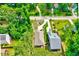 An aerial view of the home showing the roof, driveway, landscaping, and surrounding trees at 2975 Carolyn Dr, Durham, NC 27703