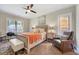 Bedroom features a ceiling fan, chair, bench, and large windows offering plenty of natural light at 2975 Carolyn Dr, Durham, NC 27703