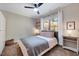 Cozy bedroom with natural light, ceiling fan, carpet, and decorative pillows on a made bed at 2975 Carolyn Dr, Durham, NC 27703