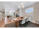 Open dining room next to kitchen and living room with a modern chandelier, table, and bright natural light at 2975 Carolyn Dr, Durham, NC 27703