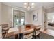 Dining room features a modern wood table and four chairs with neutral decor and natural light at 2975 Carolyn Dr, Durham, NC 27703