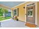 Charming front porch featuring a cozy bench, stylish lighting, and a welcoming front door at 2975 Carolyn Dr, Durham, NC 27703