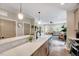Bright kitchen features an island with quartz countertops, stainless steel appliances, and subway tile backsplash at 2975 Carolyn Dr, Durham, NC 27703