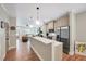 Bright open-concept kitchen with quartz countertops, stainless steel appliances, and adjacent seating area at 2975 Carolyn Dr, Durham, NC 27703