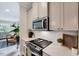 The kitchen offers quartz countertops, a stainless steel microwave and range, and bright subway tile backsplash at 2975 Carolyn Dr, Durham, NC 27703