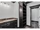 Bathroom with granite counters, shelves, and an open doorway at 318 W Lillington St, Angier, NC 27501
