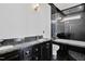Sleek bathroom featuring a stylish dark vanity, modern fixtures, and a glass-enclosed shower with bathtub at 318 W Lillington St, Angier, NC 27501