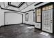 Well-lit bonus room featuring arched entryway, detailed trim, and dark tile floors at 318 W Lillington St, Angier, NC 27501