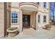 Close up view of building entrance featuring stone columns, manicured plants and an elegant front door at 318 W Lillington St, Angier, NC 27501