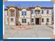 Elegant multi-level home featuring balconies, tan stucco, and an attractive circular driveway design at 318 W Lillington St, Angier, NC 27501