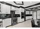 Custom kitchen with white cabinets, black countertops, and stainless steel appliances at 318 W Lillington St, Angier, NC 27501