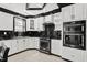 Well-lit kitchen with granite countertops, stainless steel appliances, and custom cabinetry at 318 W Lillington St, Angier, NC 27501