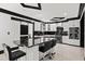 Open kitchen area with black marbling, stainless steel appliances, and bar seating at 318 W Lillington St, Angier, NC 27501