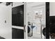 Clean laundry room with stainless steel washer and dryer behind a black sliding barn door at 318 W Lillington St, Angier, NC 27501