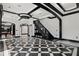 Spacious living room with a striking checkered floor, designer lighting, and views of other rooms at 318 W Lillington St, Angier, NC 27501