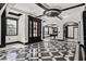 Elegant living area boasts a black and white checkered floor, arched entryways and a statement ceiling fan at 318 W Lillington St, Angier, NC 27501