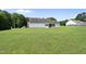 Expansive green backyard featuring a screened porch and a view of neighboring houses at 3705 Highland Creek Dr, Apex, NC 27539