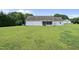 Expansive backyard featuring a lush lawn and view of the house's screened porch and back entry at 3705 Highland Creek Dr, Apex, NC 27539