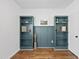 Cozy home office showcasing hardwood floors, stylish bookcases and emerald green wall accents at 3705 Highland Creek Dr, Apex, NC 27539