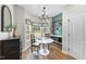 Bright breakfast nook with bay window, chandelier, built in shelving and modern decor at 3705 Highland Creek Dr, Apex, NC 27539