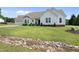 Charming white home with a two-car garage, well-maintained lawn, and a lovely creek running through the front yard at 3705 Highland Creek Dr, Apex, NC 27539