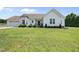 Charming white home with a well-manicured lawn, bay window, and attached two-car garage at 3705 Highland Creek Dr, Apex, NC 27539