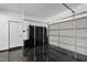 Spotless garage with epoxy floors, cabinets, and white garage door; clean and well-organized space at 3705 Highland Creek Dr, Apex, NC 27539