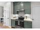 Charming kitchen featuring stainless steel appliances, green cabinetry and modern countertops at 3705 Highland Creek Dr, Apex, NC 27539