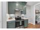 Lovely kitchen featuring custom green cabinets, stainless steel appliances, and bright countertops at 3705 Highland Creek Dr, Apex, NC 27539