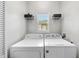 Functional laundry room with washer, dryer and shelving for storage at 3705 Highland Creek Dr, Apex, NC 27539
