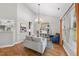 Bright living room with a vaulted ceiling, wood floors, and lots of natural light from the large window at 3705 Highland Creek Dr, Apex, NC 27539