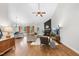 Spacious living room with wood floors, a ceiling fan, and a cozy fireplace feature at 3705 Highland Creek Dr, Apex, NC 27539