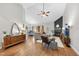 Modern living room with wood floors, vaulted ceilings, a fireplace, and neutral furniture at 3705 Highland Creek Dr, Apex, NC 27539