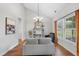 Bright living room with a vaulted ceiling, wood floors, and lots of natural light from the large window at 3705 Highland Creek Dr, Apex, NC 27539