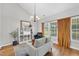 Bright living room with a vaulted ceiling, wood floors, and lots of natural light from the large window at 3705 Highland Creek Dr, Apex, NC 27539