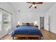 Large, light-filled main bedroom featuring a ceiling fan, laminate floor and natural lighting at 3705 Highland Creek Dr, Apex, NC 27539
