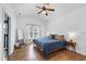 Bright and spacious main bedroom with large windows, ceiling fan and laminate floor at 3705 Highland Creek Dr, Apex, NC 27539