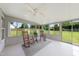 Enclosed sunroom with rocking chairs, a ceiling fan, and panoramic views of the backyard at 3705 Highland Creek Dr, Apex, NC 27539