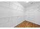 Large walk-in closet features custom shelving and laminate floors at 3705 Highland Creek Dr, Apex, NC 27539