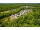 An aerial shot showcases a community surrounded by lush trees and greenery at 386 Monteith Dr, Chapel Hill, NC 27516