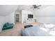 Finished attic featuring neutral carpet, a television, and a comfortable seating area at 386 Monteith Dr, Chapel Hill, NC 27516
