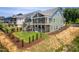 Shot of a two-story home with a spacious backyard, slide, colorful climbing dome and wooded area at 386 Monteith Dr, Chapel Hill, NC 27516
