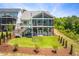 An expansive green backyard with a two-story deck, a spiral slide and a dome climber at 386 Monteith Dr, Chapel Hill, NC 27516
