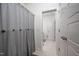 Bathroom featuring a shower with a gray striped curtain and a doorway to a bright, tiled space at 386 Monteith Dr, Chapel Hill, NC 27516