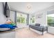 Bright bedroom with large windows offering views of the surrounding landscape and a comfortable daybed at 386 Monteith Dr, Chapel Hill, NC 27516