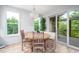 Bright breakfast nook featuring a round wooden table, built-in bench, and access to the outdoor deck at 386 Monteith Dr, Chapel Hill, NC 27516