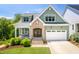 Charming two-story home with green siding, brick accents, and a well-manicured lawn at 386 Monteith Dr, Chapel Hill, NC 27516