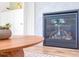 Close-up view of the modern fireplace with a hexagonal tile surround and a rustic mantel at 386 Monteith Dr, Chapel Hill, NC 27516