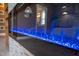 Electric fireplace with blue flame effect and tiled surround, adding a modern touch at 386 Monteith Dr, Chapel Hill, NC 27516