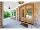 Charming arched double front doors with brick accents and view of the inviting porch at 386 Monteith Dr, Chapel Hill, NC 27516